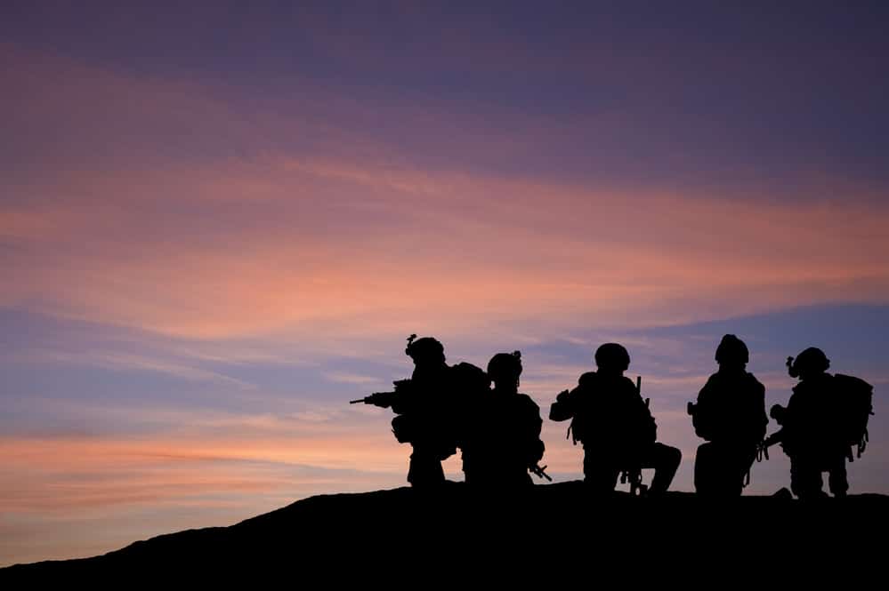 silhouette of military on mission.