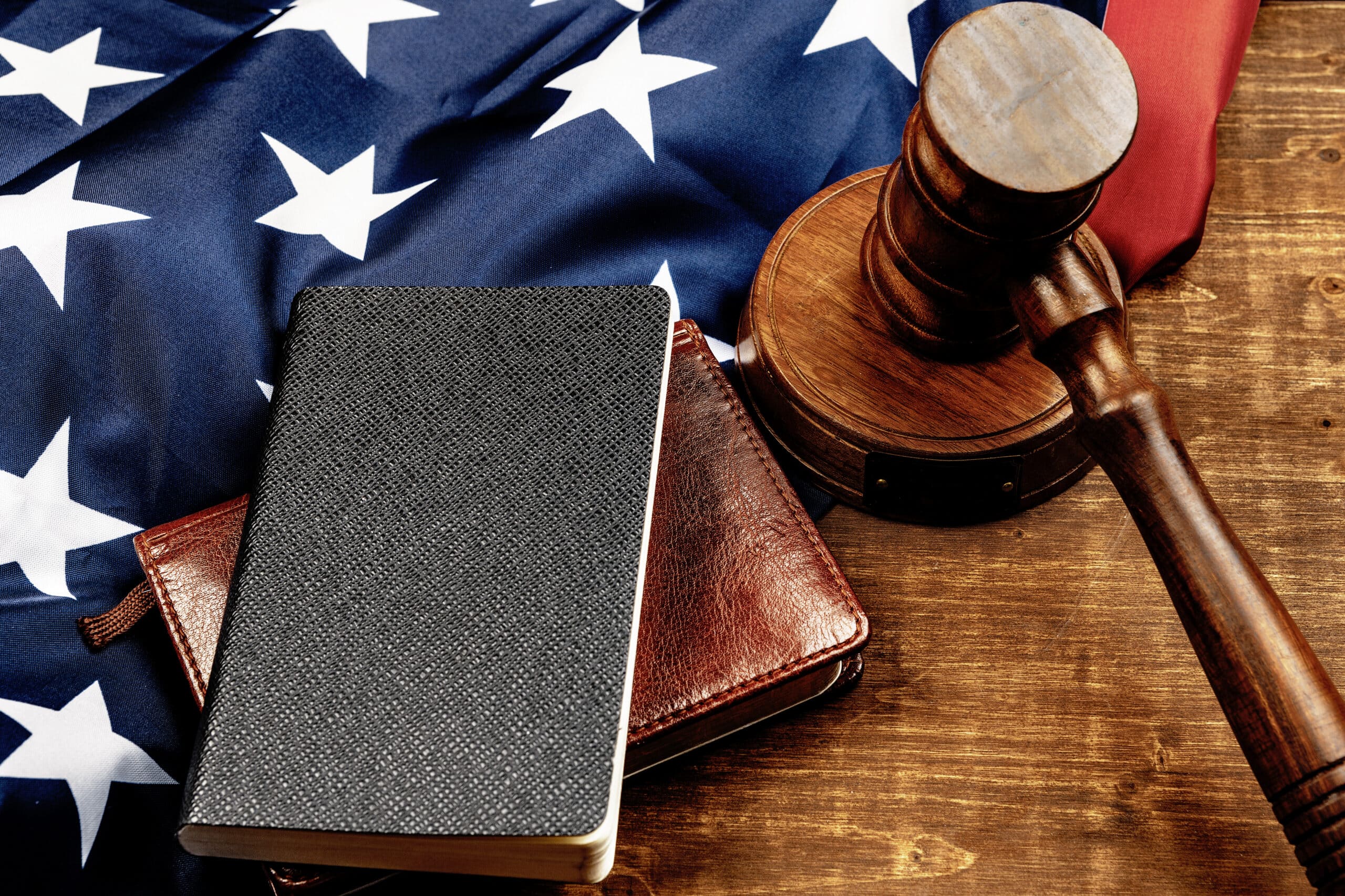 Image of wooden judge hammer on notepad
