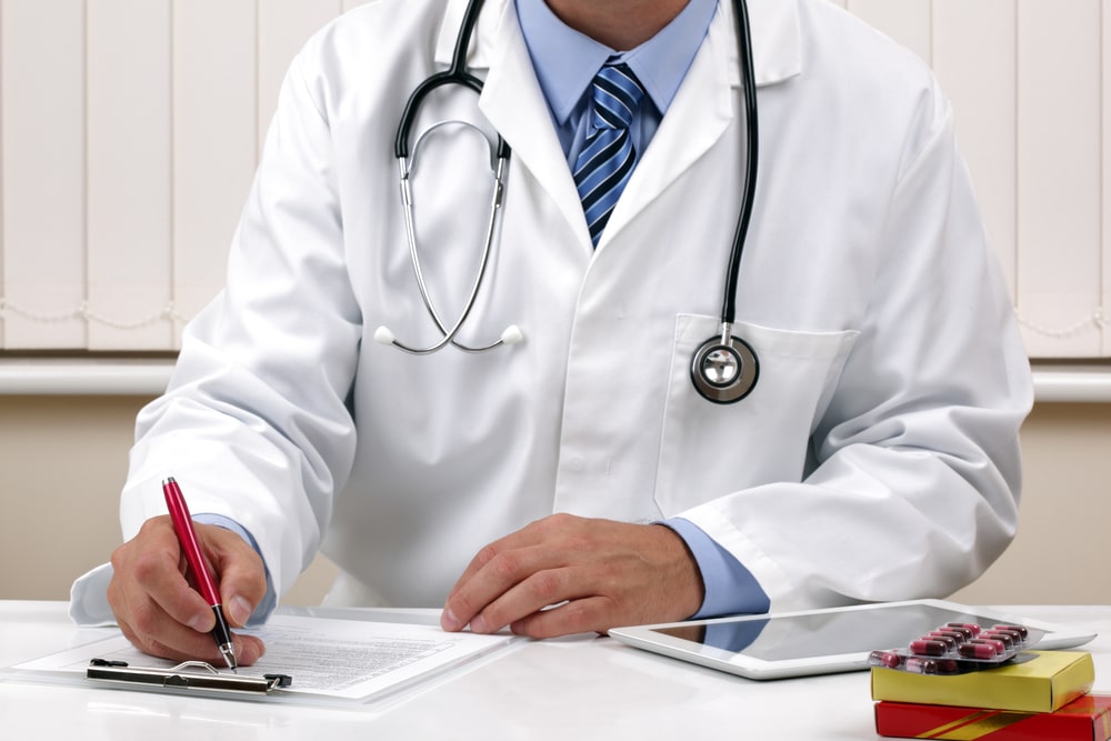 Doctor writing a prescription or medical examination notes