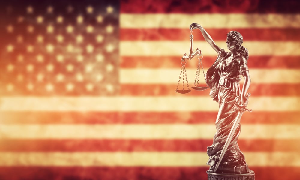 Themis statue against USA flag.