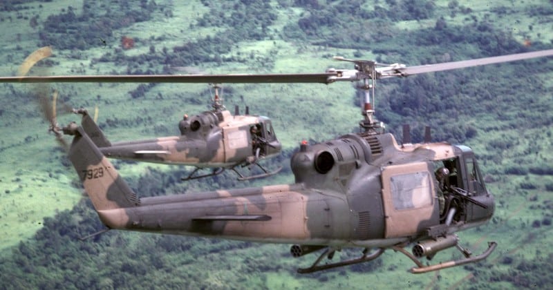 two USAF UH-1P helicopters flying over cambodian jungle 1970