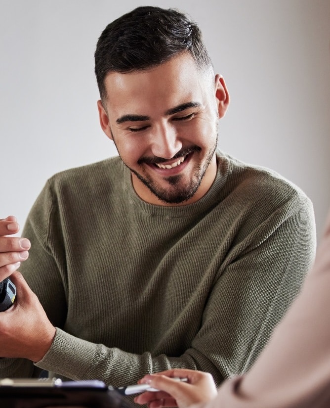 young veteran smiling and filling paperwork