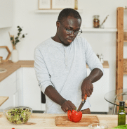 Veteran chopping vegetables preparing healthy food