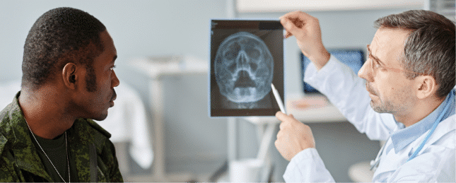Doctor reviewing brain scan with veteran patient